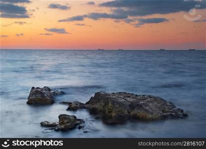 Sunset on the sea. Landscape with rocks and beautiful sky.