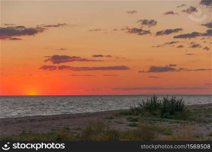 Sunset on the sea. The last rays of the setting sun over the shore (Azov sea)