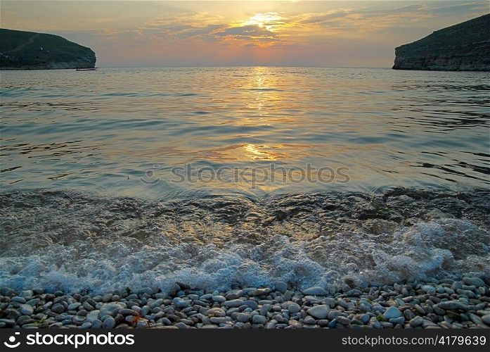 Sunset on the sea with the waves.