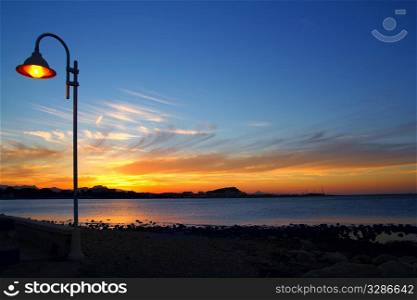 Sunset orange blue seascape light lamppost Mediterranean Denia alicante spain