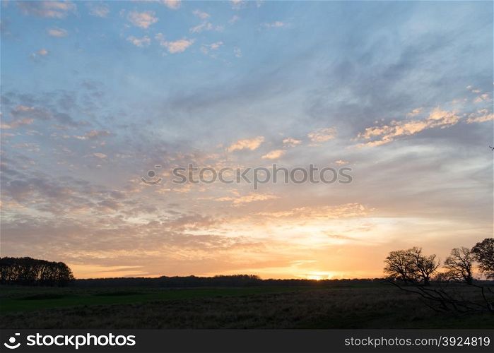 Sunset over a field in Denmark in autumn. Sunset over a field in Denmark in autumn with nordic landscape and trees