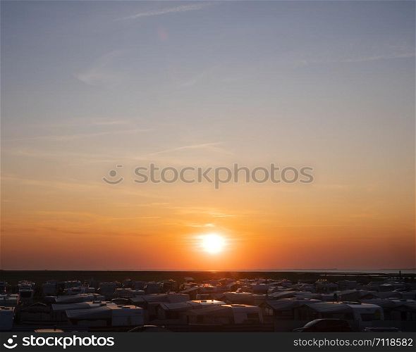 sunset over a lot of caravans on german campingside in the north near north sea in late summer