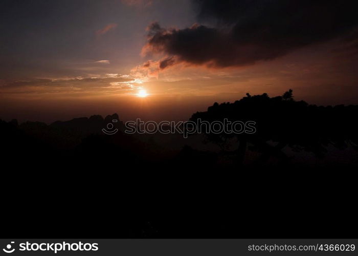 Sunset over a mountain, Huangshan Mountains, Anhui Province, China