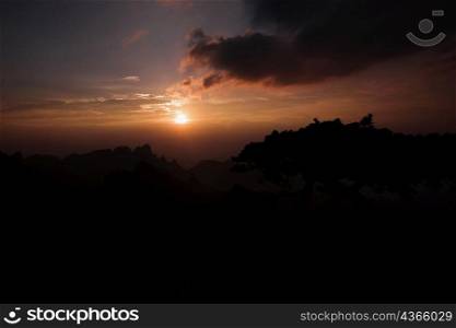 Sunset over a mountain, Huangshan Mountains, Anhui Province, China