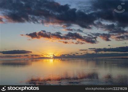 Sunset over Aitutaki Lagoon in the Cook Islands in the South Pacific.