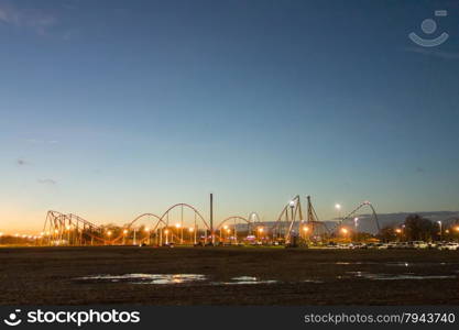 sunset over an amusement park in a distance