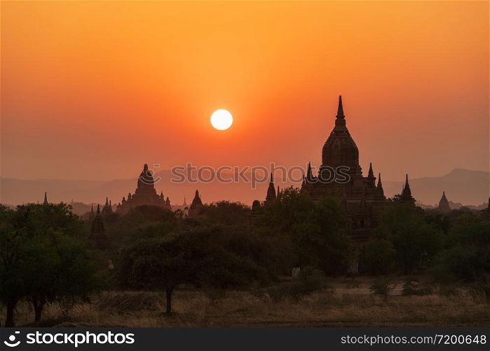 Sunset over ancient temples, pagodas and stupas in Old Bagan, Myanmar Peaceful Asian landscape with Buddhist temple silhouettes. Sacred, serene sky and beautiful scenery.