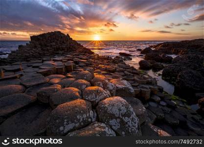 sunset over basalt columns Giant&rsquo;s Causeway known as UNESCO World Heritage Site, County Antrim, Northern Ireland. sunset over basalt columns Giant&rsquo;s Causeway, County Antrim, Northern Ireland