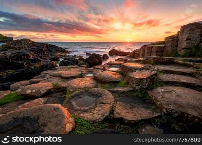 sunset over basalt columns Giant’s Causeway known as UNESCO World Heritage Site, County Antrim, Northern Ireland. sunset over basalt columns Giant’s Causeway, County Antrim, Northern Ireland