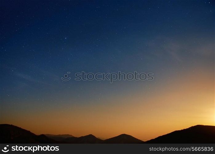 Sunset over blue dark night sky with many stars. Space background