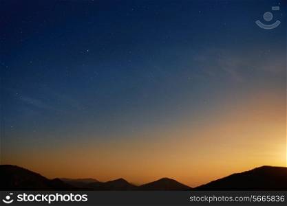 Sunset over blue dark night sky with many stars. Space background