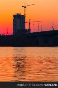 sunset over bridge and river in city. Kiev, Ukraine. sunset over bridge