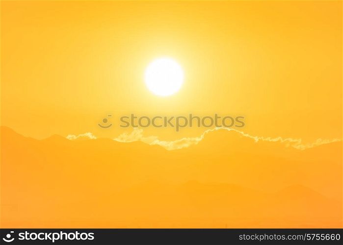 Sunset over clouds. Big orange sun can be used for natural background