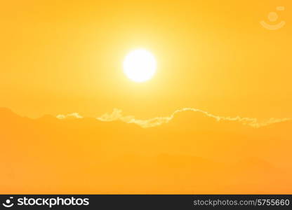 Sunset over clouds. Big orange sun can be used for natural background