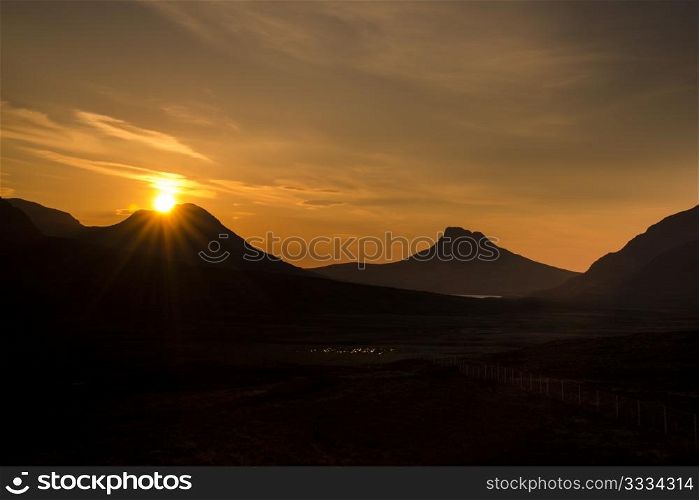 Sunset over Coigach and the unmistakeable Stac Pollaidh, Scottish Highlands.
