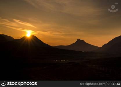 Sunset over Coigach and the unmistakeable Stac Pollaidh, Scottish Highlands.