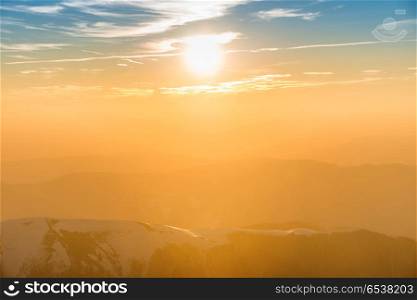 Sunset over hills and mountains. Sunset over hills and mountains with snow