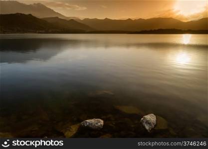 Sunset over Lac de Codole at Reginu in the Balagne region of Corsica with mountains in background