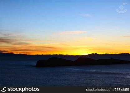 Sunset over Lake Titicaca and the island Jochihuata photographed from the northern end of the popular tourist destination of Isla del Sol (Island of the Sun) in Bolivia