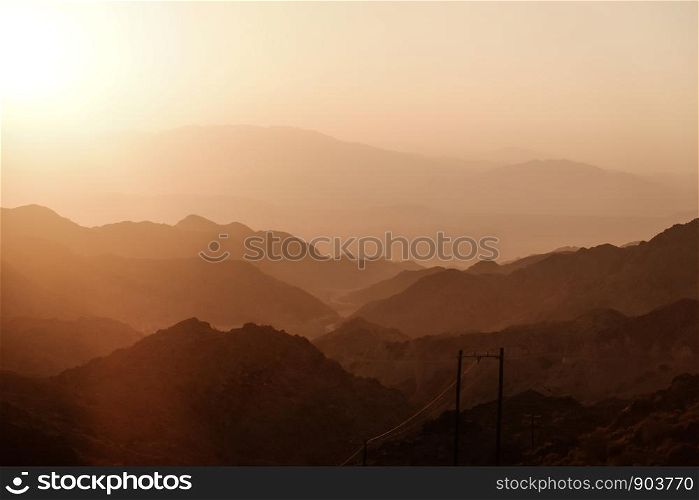 Sunset over layers of mountain range in Iran.