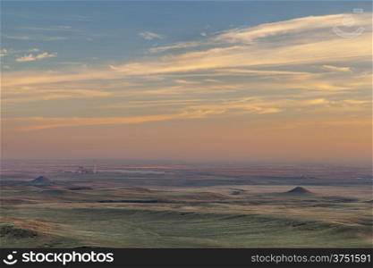 sunset over prairie in northern Colorado near Fort Collins with a distant power plant