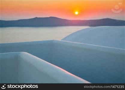 sunset over sea and white buildings Santorini Greece
