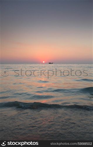 Sunset over sea. Beautiful sunset over sea and fishing boat