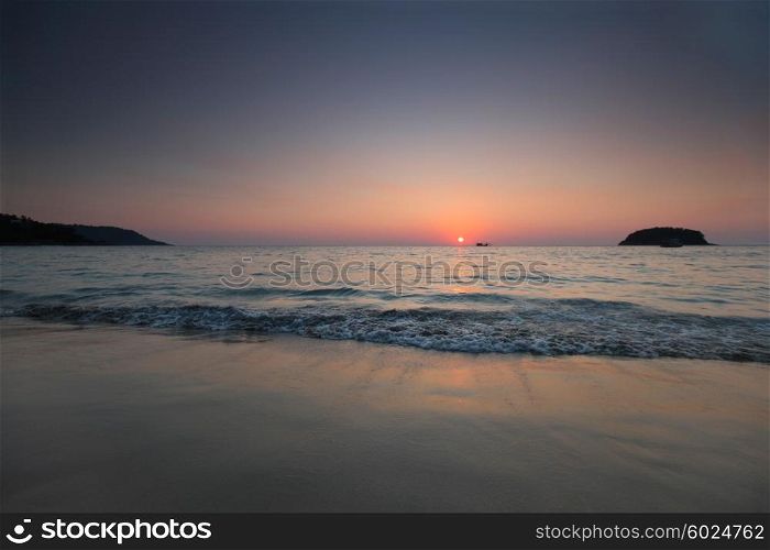 Sunset over sea in Thailand. Sunset over sea and silhouette of traditional longtail boat in Thailand