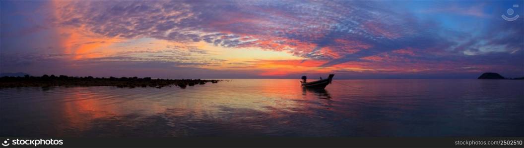Sunset over sea with fisherman boat panorama