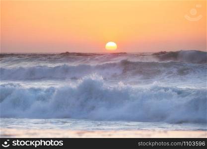 Sunset over the ocean. Panorama of ocean waves and setting sun. Florida, USA