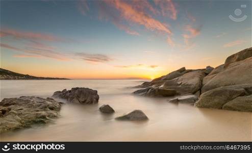 Sunset over the rocks at Algajola beach in northern Corsica