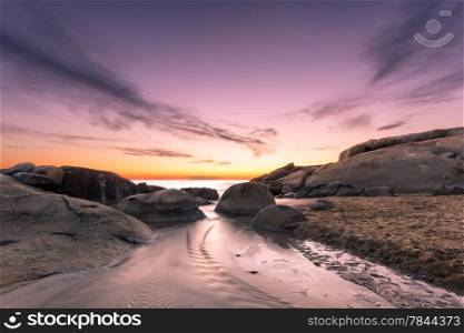 Sunset over the rocks at Algajola beach in northern Corsica