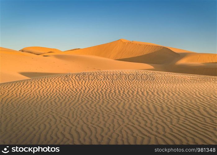 Sunset over the sand dunes in the desert
