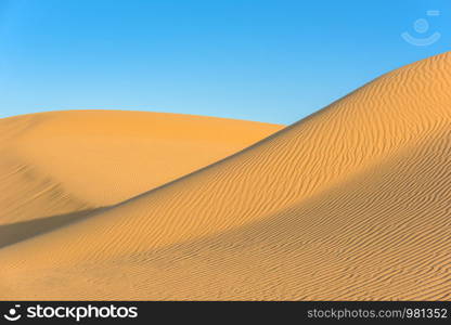 Sunset over the sand dunes in the desert