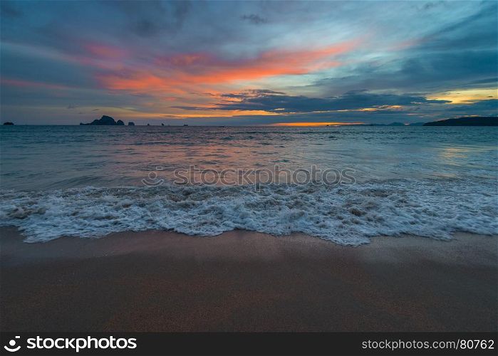 sunset over the sea, a photograph in dark blue and orange colors