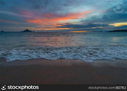 sunset over the sea, a photograph in dark blue and orange colors