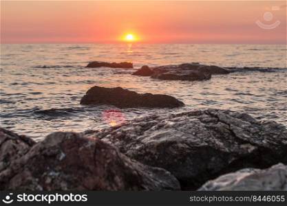 Sunset over the sea among the rocks.. Sunset over the sea among the rocks