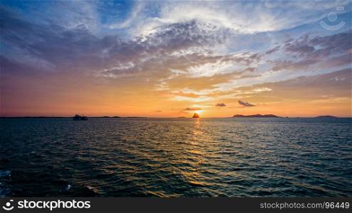 Sunset over the sea in Thailand. Beautiful natural landscape of colorful cloud sky and sun at sunset over the sea in Surat Thani province, Thailand, 16:9 widescreen