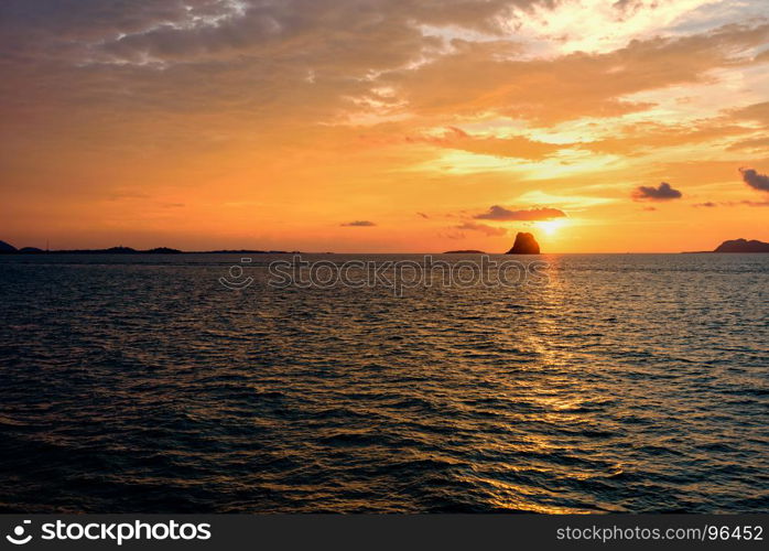 Sunset over the sea in Thailand. Beautiful natural landscape of colorful cloud sky and sun at sunset over the sea in Surat Thani province, Thailand