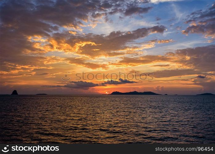 Sunset over the sea in Thailand. Beautiful natural landscape of colorful cloud sky and sun at sunset over the sea in Surat Thani province, Thailand