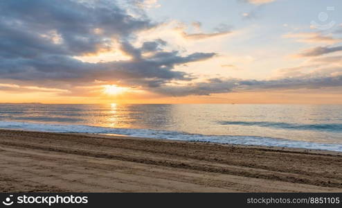 Sunset over the sea with clouds and rays of light on the horizon Miami Playa Spain 