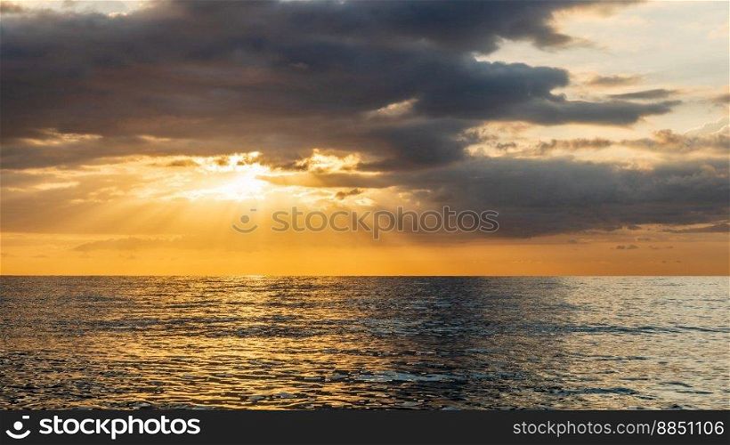 Sunset over the sea with clouds and rays of light on the horizon Miami Playa Spain 