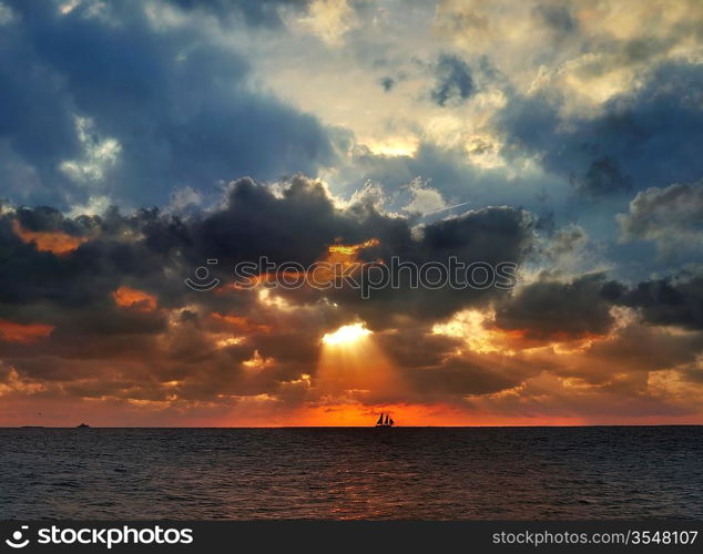 Sunset Over The Sea With Sailing Boat