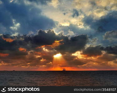 Sunset Over The Sea With Sailing Boat