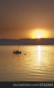 Sunset over the sea with sailing boat. Vilagarcia, Pontevedra, Spain