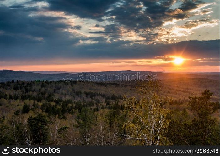 Sunset over the spring forest. South Ural.