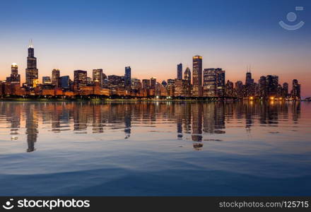 Sunset over the tall skyscrapers of Chicago from The Observatory with artificial water reflection. Chicago Skyline at sunset from the Observatory