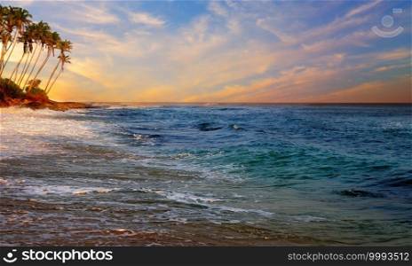 Sunset over the tropical beach. Concept of romantic time on vacation in tropical.