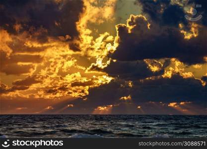 Sunset, ray of sunlight over sea, stormy clouds. Seaside landscape in the evening.. Sunset over sea, stormy clouds