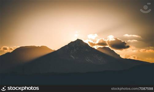 Sunset scenery on a mountain, cloudy sky